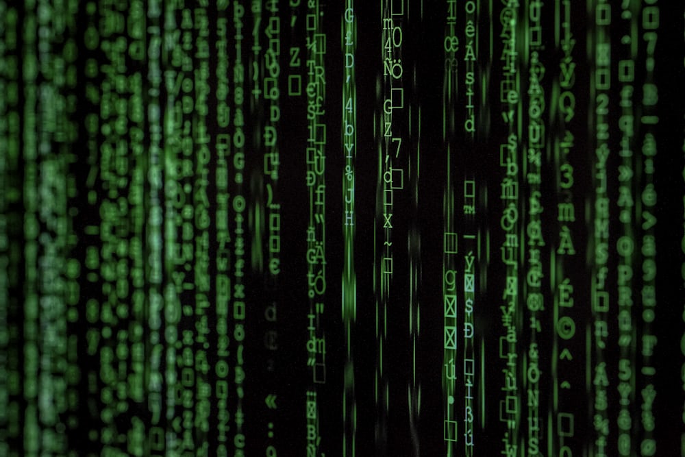 A dark screen filled with cascading columns of glowing green characters.